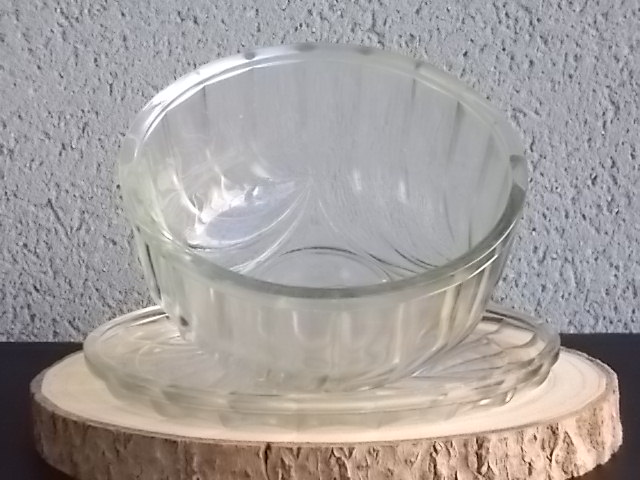 Cloche sur plateau en verre translucide moulé pressé. Forme Dôme, motif en relief de drapé, poignée plate facetté.