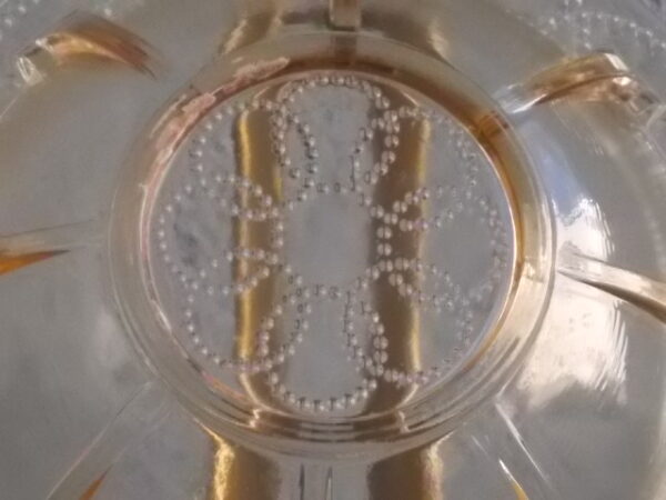 Sucrier couvert en verre teinté Ambre, moulé pressé. Bol à rebord perlé plat avec effet piliers de soutient. Base fond cercles entrelacés perlés. Couvercle Dôme, bouton conique.