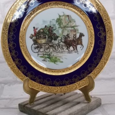 Assiette décorative en porcelaine, véritable Bleu de Four de "Limoges France", décor "Voyage en Diligence" rehaussé main, frise double Dorure